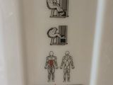 a sign on the wall of a public restroom