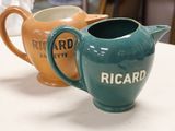 two pitchers that are sitting on a table