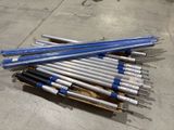 a pile of blue and white baseball bats on a pallet