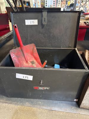 a black box with a red shovel inside of it