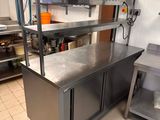 a kitchen with stainless steel counter tops and stainless steel cabinets