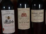 several bottles of wine are lined up on a table