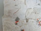 a lot of baby clothes that are sitting on a table