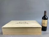 a wooden box with a bottle of wine next to it