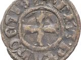 une vieille pièce d'argent sur laquelle figure une croix au recto