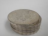 several coins stacked on top of each other on a white surface