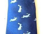 a blue neck tie with white birds on it