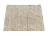 a beige and white rug with a geometric design on it