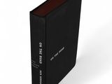 a black book sitting on top of a white surface