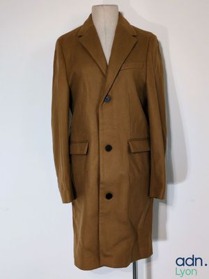 brown wool coat on a mannequin stand on a white background