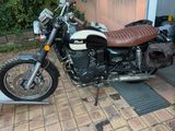 a motorcycle that is parked in front of a house