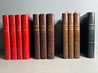 several old books are lined up on a shelf in a row
