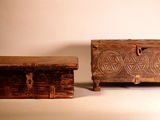 two wooden chests sitting next to each other on a white surface