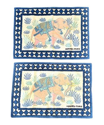 two blue and white rugs with elephants and plants on them