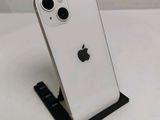 an apple iphone is sitting on a stand on a white surface
