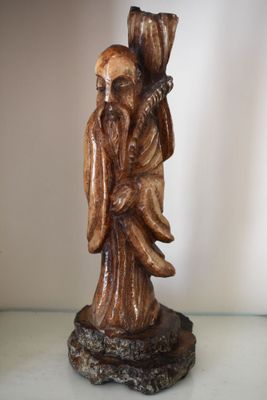a statue of a man with a bird on his shoulder