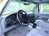 a view of the inside of a car from the driver ' s seat