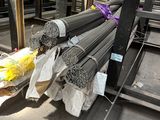a pile of steel rods sitting on a pallet in a warehouse
