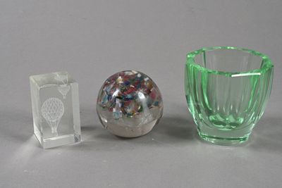 two glass vases and a glass ball on a table