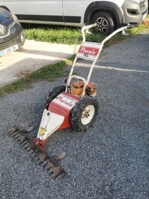 a small lawn mower that is sitting on the side of the road