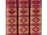 a set of four red books with gold trimmings on them