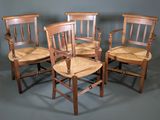 three wooden chairs with woven seats against a gray background