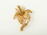 an image of a gold palm tree brooch on a white background