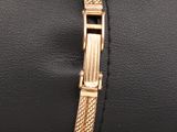 a close up of a gold bracelet with a clasp on it