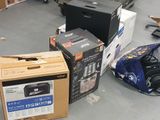many boxes of electronics sitting on the floor in a room