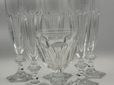 six clear wine glasses sitting on top of each other on a table