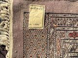 an image of a close up of a rug with a tag on it