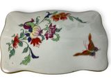 a plate with a butterfly and flowers on it