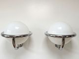 pair of chrome and glass sconces on a white wall