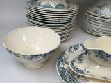 a lot of plates and bowls sitting on a table