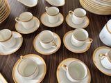 a lot of cups and saucers on the table