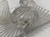 a glass container with a bird on it on a tray