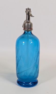 une bouteille en verre bleue munie d'un bouchon en métal