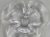 a glass bowl with an apple in it on a table