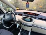 a car dashboard with a steering wheel and a clock on it