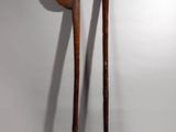 pair of wooden spoons on a white background with a shadow