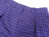 a close up of a purple suit with a white checkered pattern on it