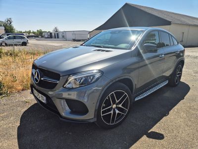 the mercedes gle is parked in front of a building