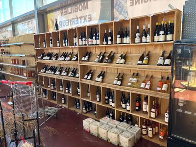 many bottles of wine on the shelves in the store
