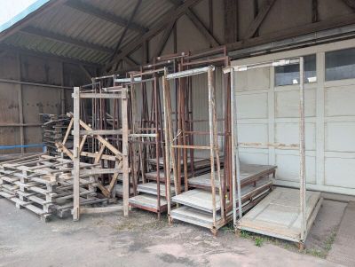 a garage with a lot of wooden pallets in front of it