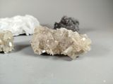 three different kinds of crystals on a table with a white background