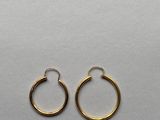 a pair of gold hoop earrings on a white background