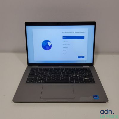 an open laptop computer sitting on top of a white table