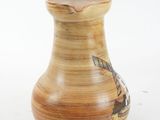 a small vase with a picture on it sitting on a table