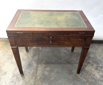 a small wooden table with a glass top on it
