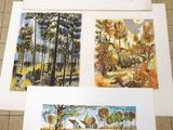 four prints of watercolor paintings of trees and a lake